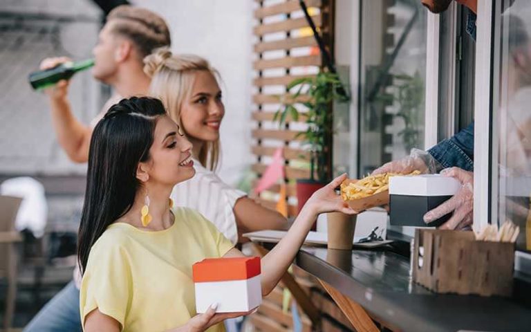 food truck chef giving french fries to customer at food trucks heaven kissimmee