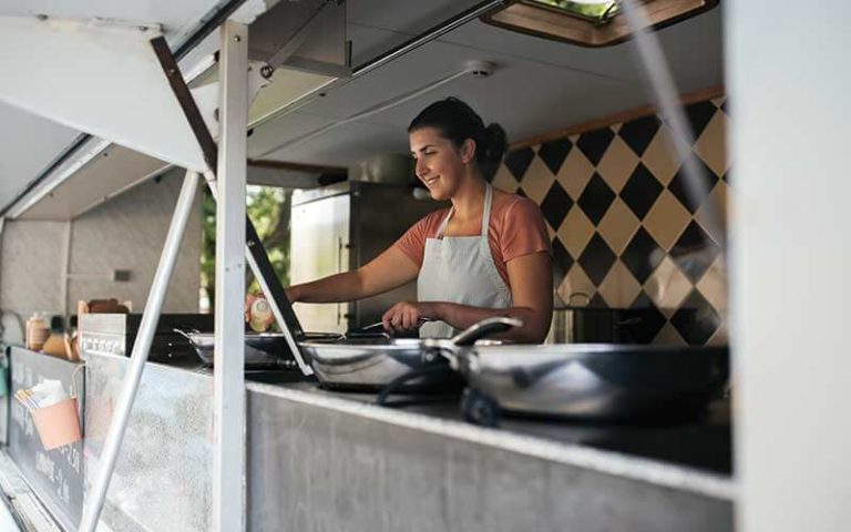 smiling female food truck chef cooking preparing food at food trucks heaven kissimmee