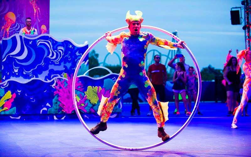 acrobat in hoop parade performer with neon blacklight effects for electric ocean at seaworld orlando