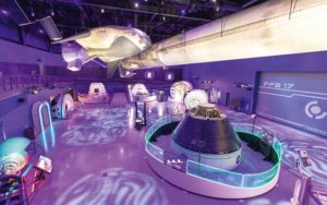 futuristic space exhibits in purple lighting at gateway building at kennedy space center visitor complex for enjoy florida blog