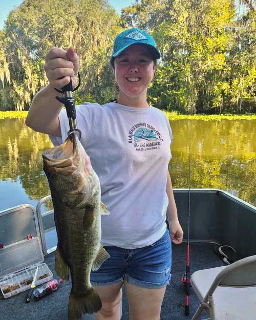 girl holding large fish for monster bass fishing charters