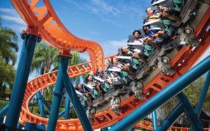 riders rushing by on ice breaker coaster with orange rails and blue posts at seaworld orlando enjoy florida blog