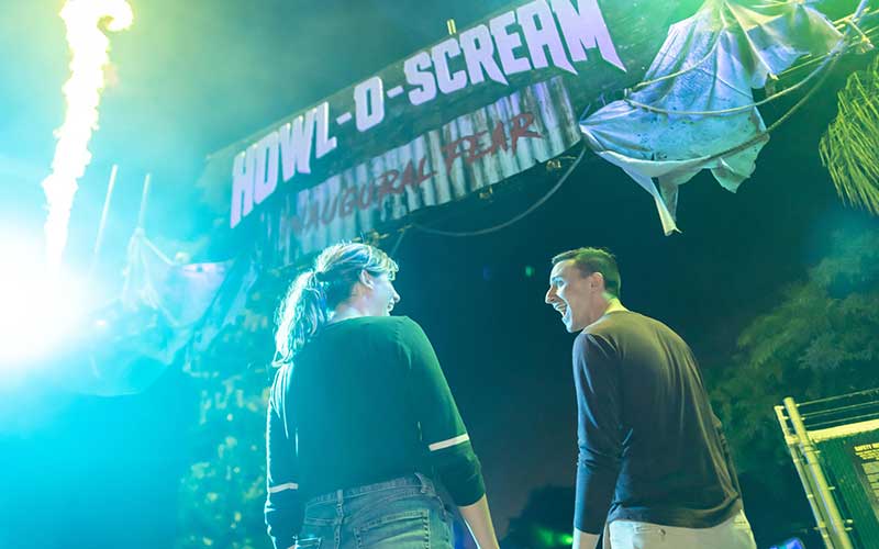 young man and lady scream while walking through gate at seaworld halloween themed event for seaworld howl o scream on enjoy florida blog