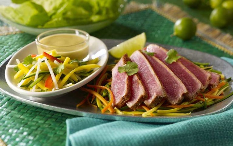 blue and green decor plate with spicy seared ahi tuna fajitas avocado sauce and lime at uncle julios mexican restaurant icon park orlando