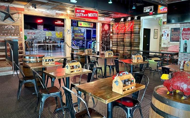 interior dining area with tables and barbecue themed southern decor at brother jimmys icon park orlando