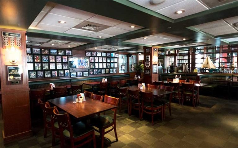 interior of restaurant and bar with dark wood and nautical theme at celebration town tavern