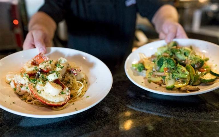 two gourmet dishes prepared with seafood at celebration town tavern