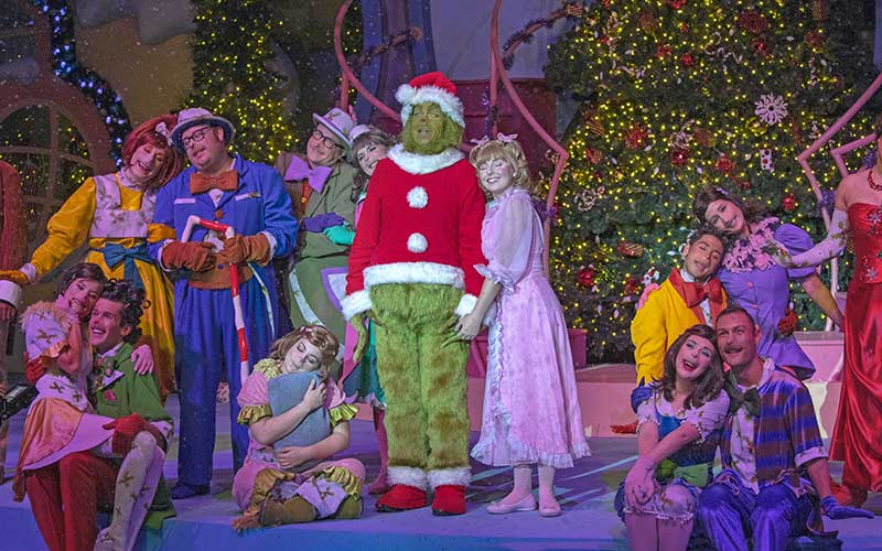 cast members on stage for grinchmas show at universal orlando resort