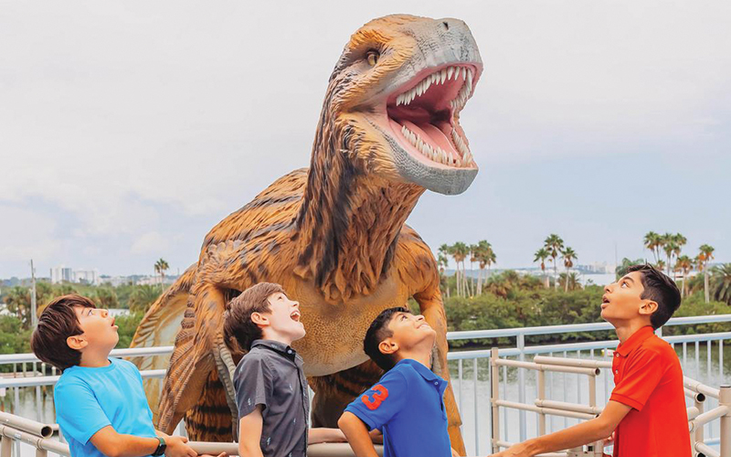 four boys roar along with towering model of t rex at dino rescue clearwater marine aquarium