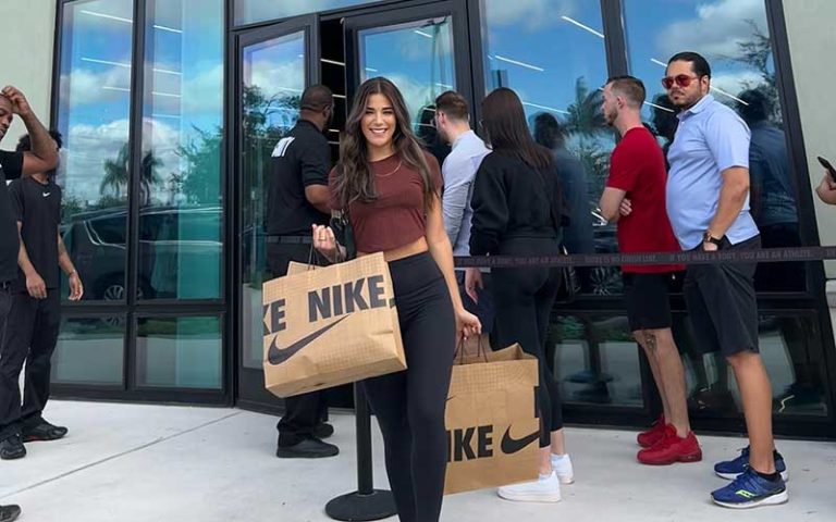 young lady shopper leaving nike outlet with bags at dania pointe fort lauderdale