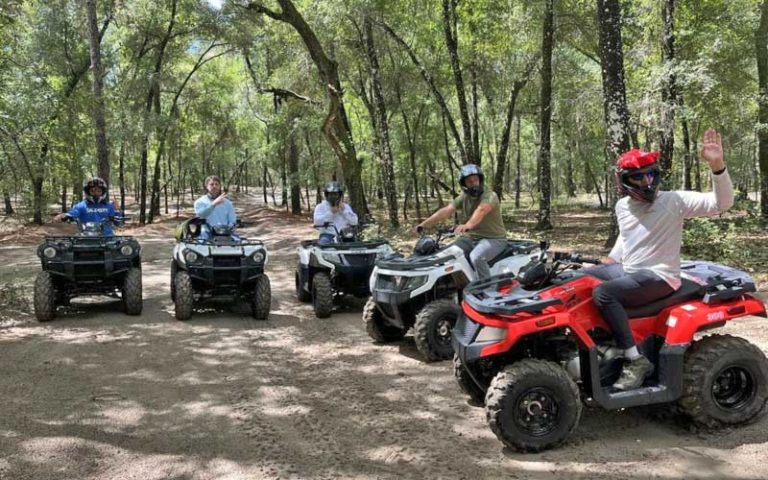 group of atvs ready to ride through forest area at moore atv rentals