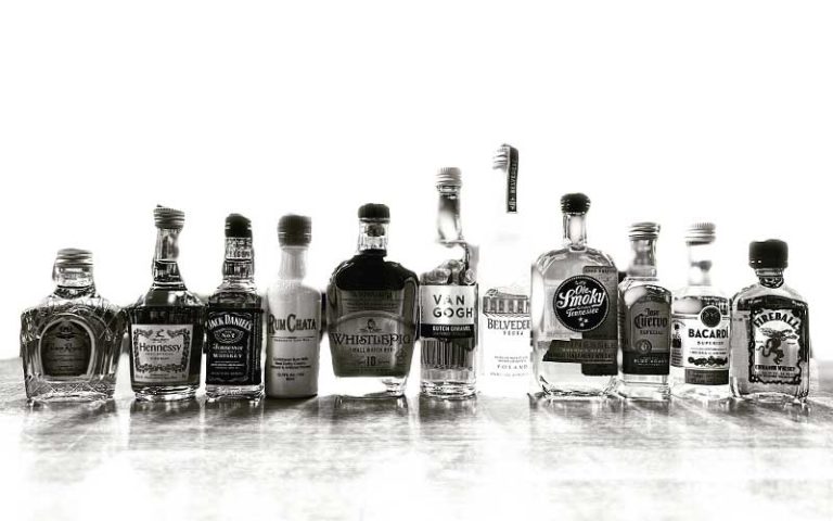 row of monochrome top shelf liquor bottles at airport liquor orlando
