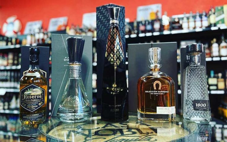 row of ornate liquor bottles with rum and tequila top shelf liquor brands at airport liquor orlando