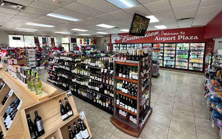 store floor with aisles of alcohol selections and coolers at airport liquor orlando