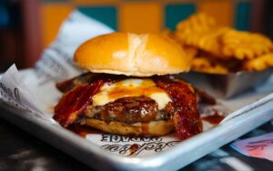barbecue burger with cheese and bacon entree with waffle fries at sickies garage burgers and brews kissimmee