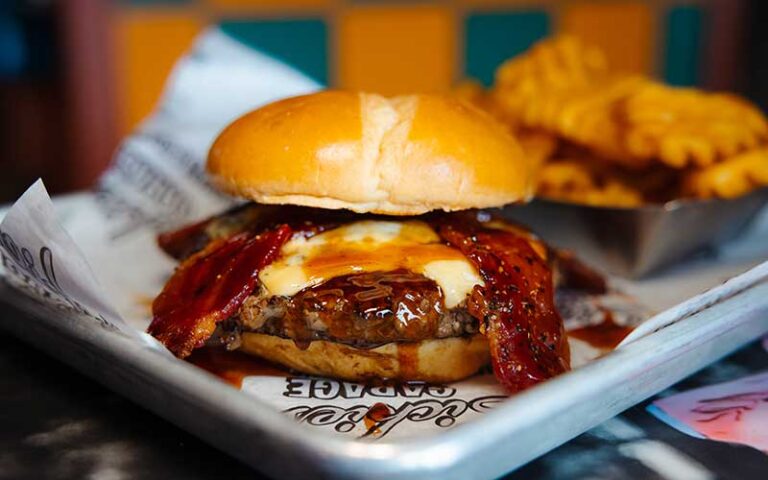 barbecue burger with cheese and bacon entree with waffle fries at sickies garage burgers and brews kissimmee