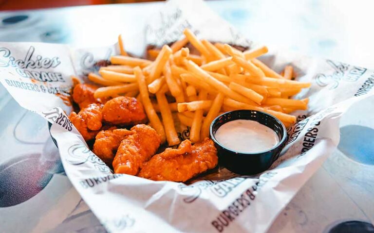 basket of hot wings with white sauce and fries at sickies garage burgers and brews kissimmee