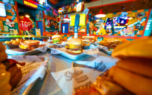 dining table with several sandwich entrees at sickies garage burgers and brews