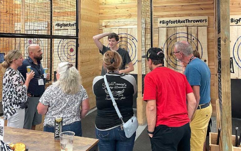 guide teaches group throwing skills with targets behind at bigfoot axe throwing and rage room