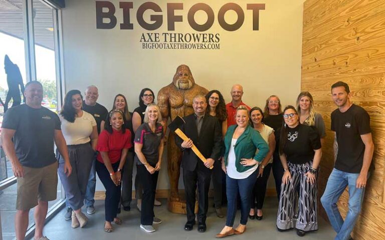 large group in front room with logo and statue of bigfoot at bigfoot axe throwing and rage room