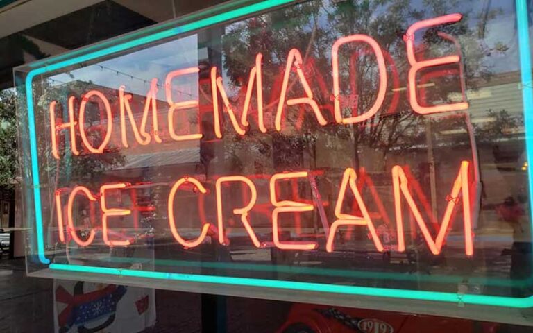 neon homemade ice cream sign in shop window facing street at sweet dreams cafe old town