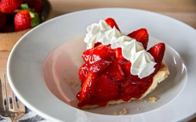 piece of strawberry pie with whipped cream in white bowl at shoneys kitchen and bar old town
