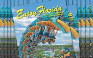 stacks of magazines with looping roller coaster flying through the air at seaworld on enjoy florida magazine cover for summer 2023 things to do in orlando