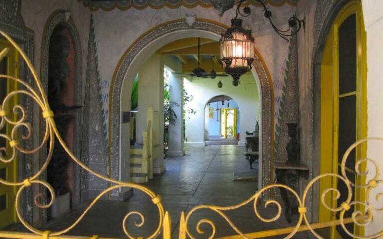 arched doorways through outdoor pavilion in garden with gate at bonnet house museum gardens ft lauderdale