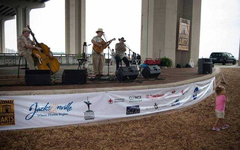 band performing on outdoor stage under bridge at riverside arts market jacksonville