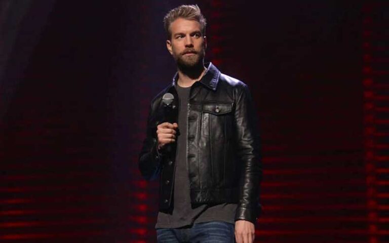 bearded standup comedian with microphone on stage at florida theatre jacksonville