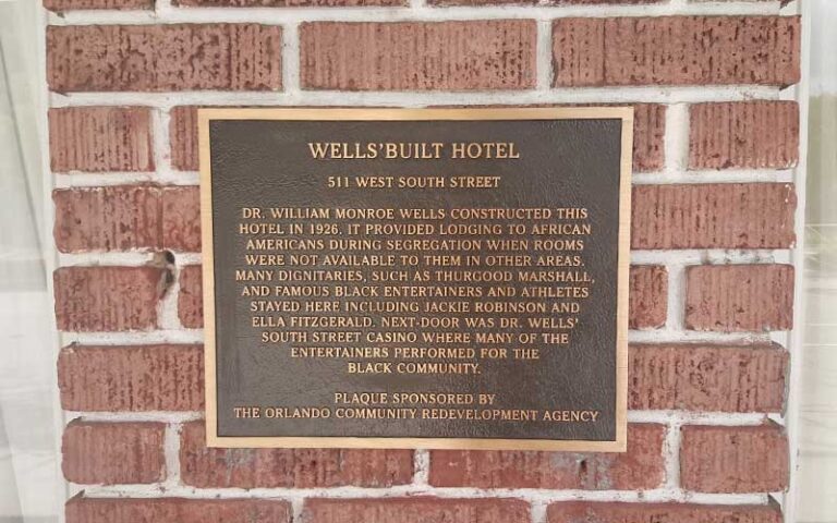 bronze plaque on red brick wall at wells built museum orlando