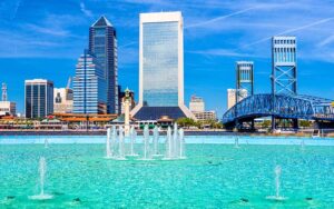 city skyline with bridge and large pool below with multiple fountains at friendship fountain jacksonville