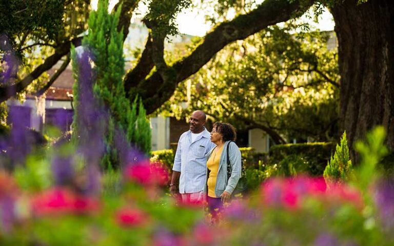 couple admiring flowers in garden area at cummer museum of art and gardens jacksonville