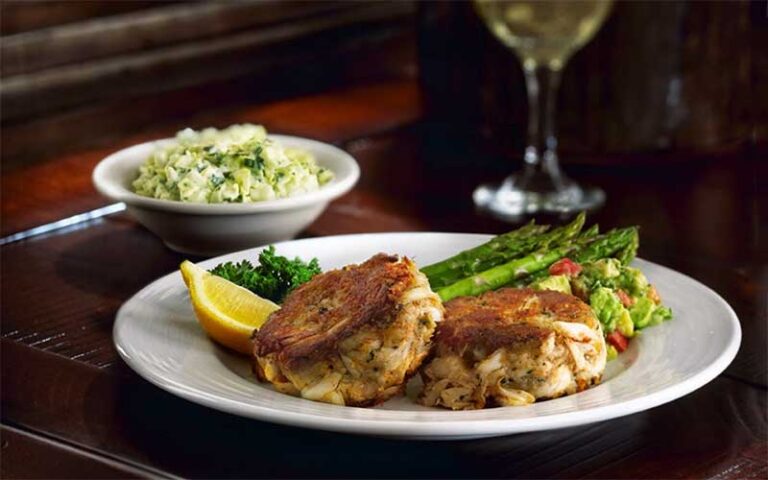 crab cakes entree with slaw side and wine glass at teds montana grill jacksonville