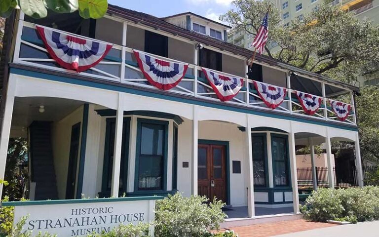 daytime front exterior of victorian house with double veranda at historic stranahan house museum ft lauderdale