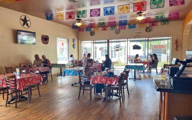 dining room area with tables and colorful flags at casita tejas homestead