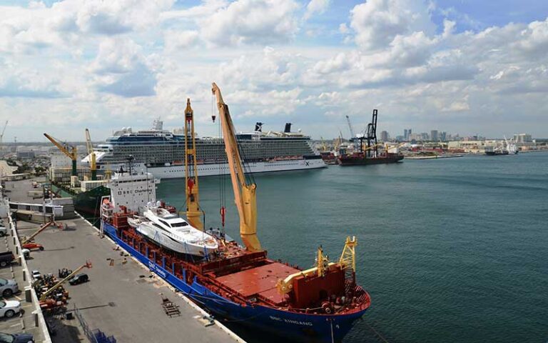 docked cargo ship with yacht on deck and cruise ship behind at port everglades ft lauderdale