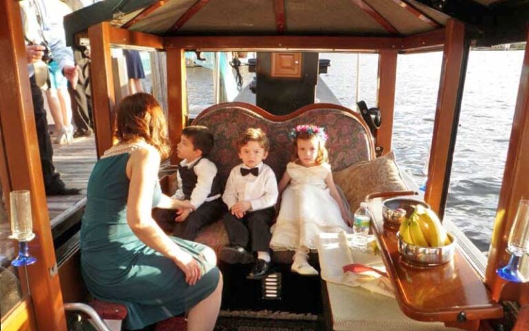 dressed up kids with mom sitting in boat at las olas gondola fort lauderdale