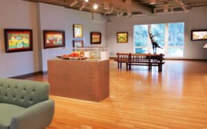 exhibit space with sofa paintings and sculptures at mennello museum orlando