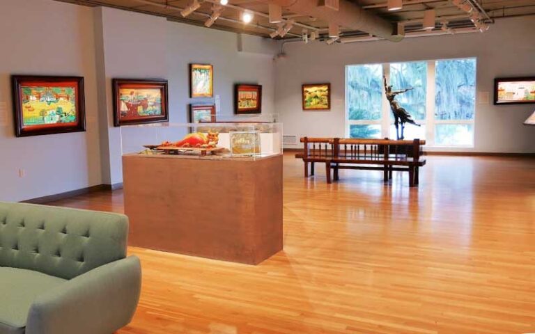 exhibit space with sofa paintings and sculptures at mennello museum orlando