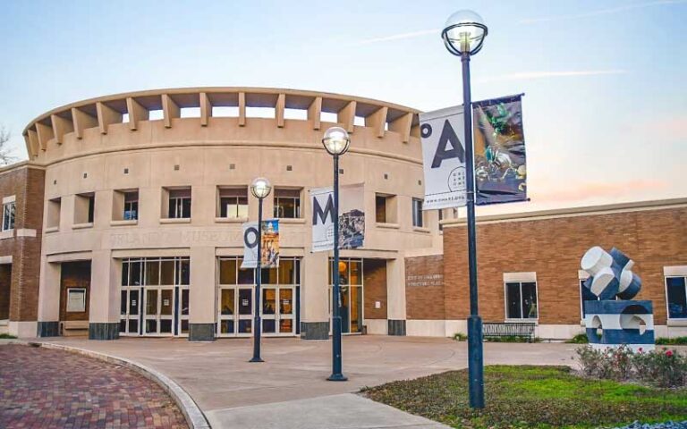 front exterior of building with art show banners on lampposts at orlando museum of art