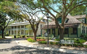 front exterior of two historic buildings with trees at history fort lauderdale museum