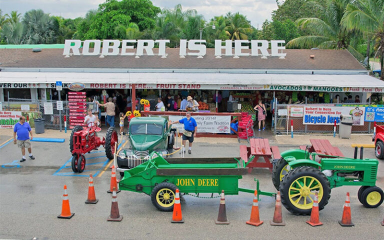 front exterior with tractors and classic trucks and founder at robert is here fruit stand homestead