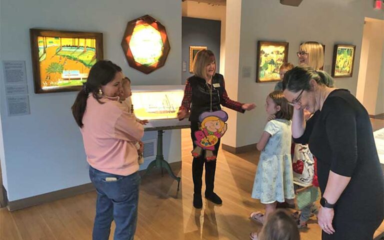 group in exhibit space with mothers kids and docent at mennello museum orlando