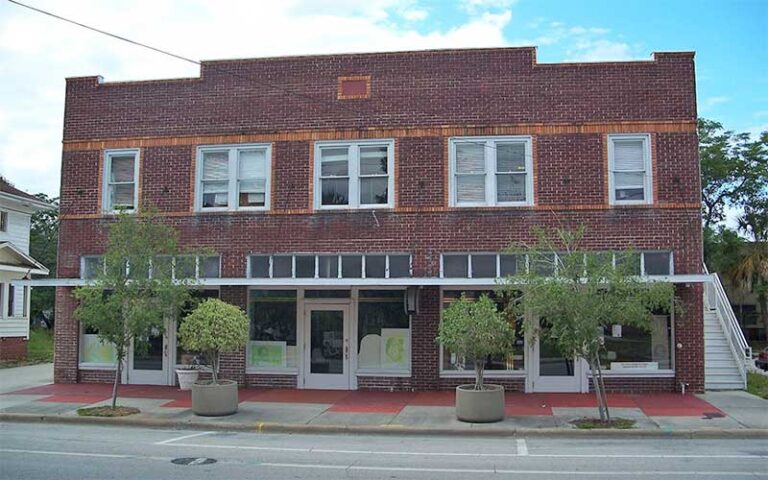historic building in city area with red brick and shop windows at wells built museum orlando