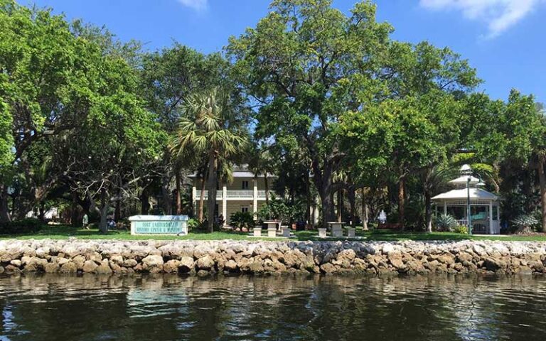 historic buildings gazebo and sign along bank of river at history fort lauderdale museum
