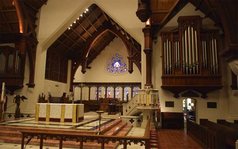 interior of church with naves and open wood beam ceiling at st johns cathedral jacksonville