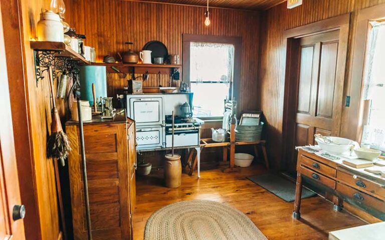 interior of old restored wood victorian kitchen with oven and washboard at historic stranahan house museum ft lauderdale