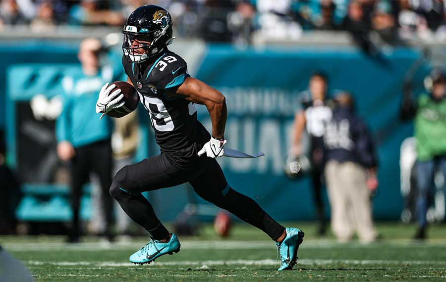 jaguars football player running with ball with stadium sidelines in background at tiaa bank stadium for jacksonville fun facts post