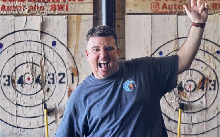 man cheering after a successful axe throw with targets at autobahn indoor speedway events jacksonville